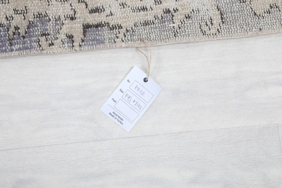 Tag attached to the rug, indicating its origin and material