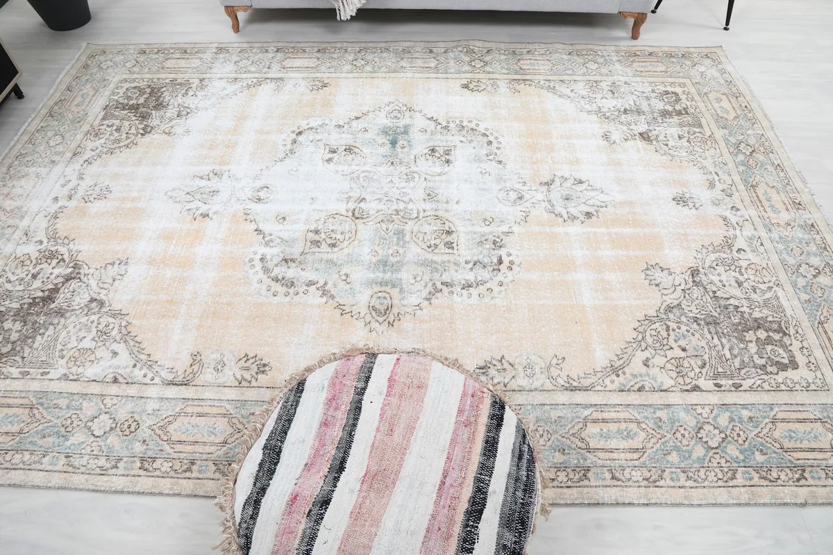 Overhead perspective of the rug with a striped pouf, showing the central design