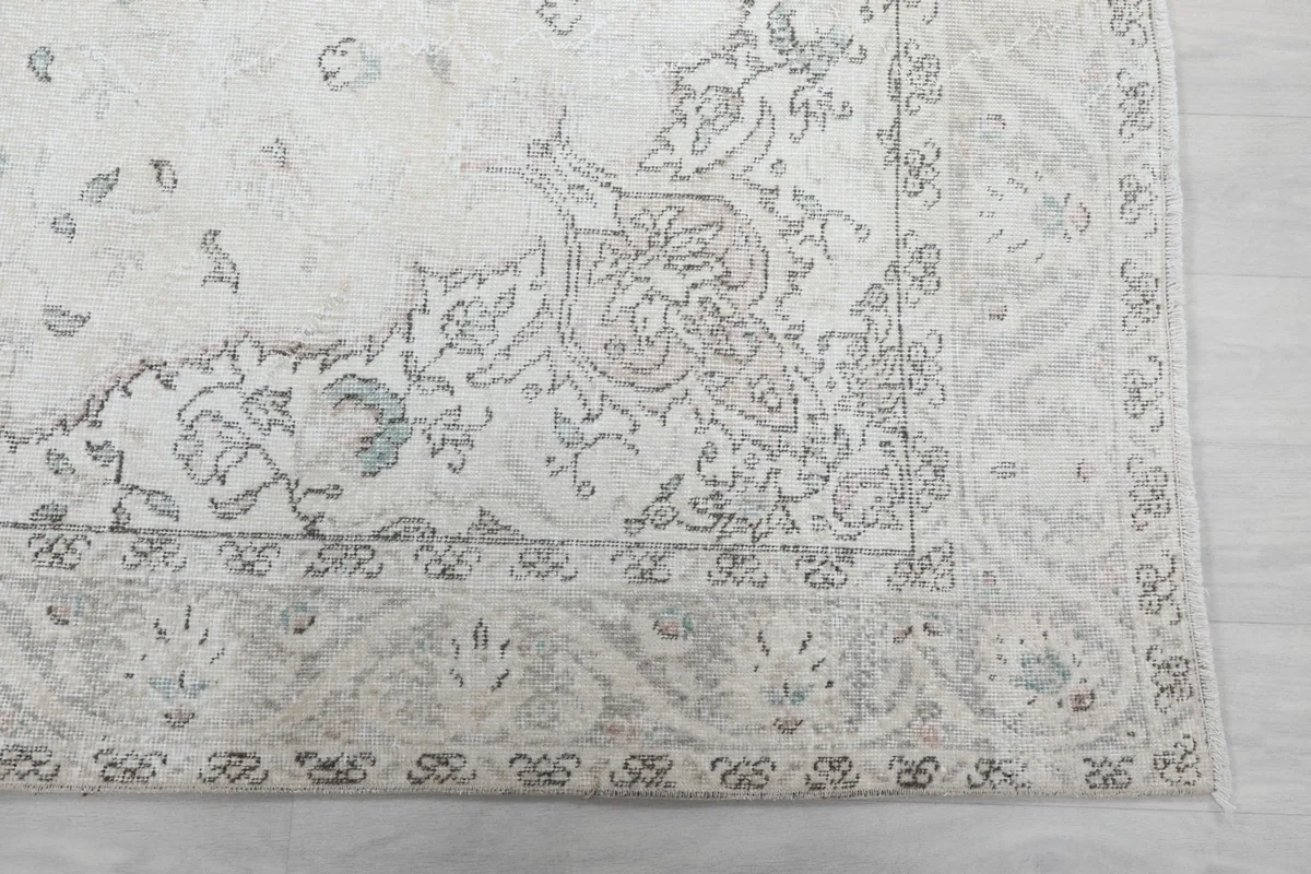 Detailed corner view of the rug showing floral motifs and border patterns