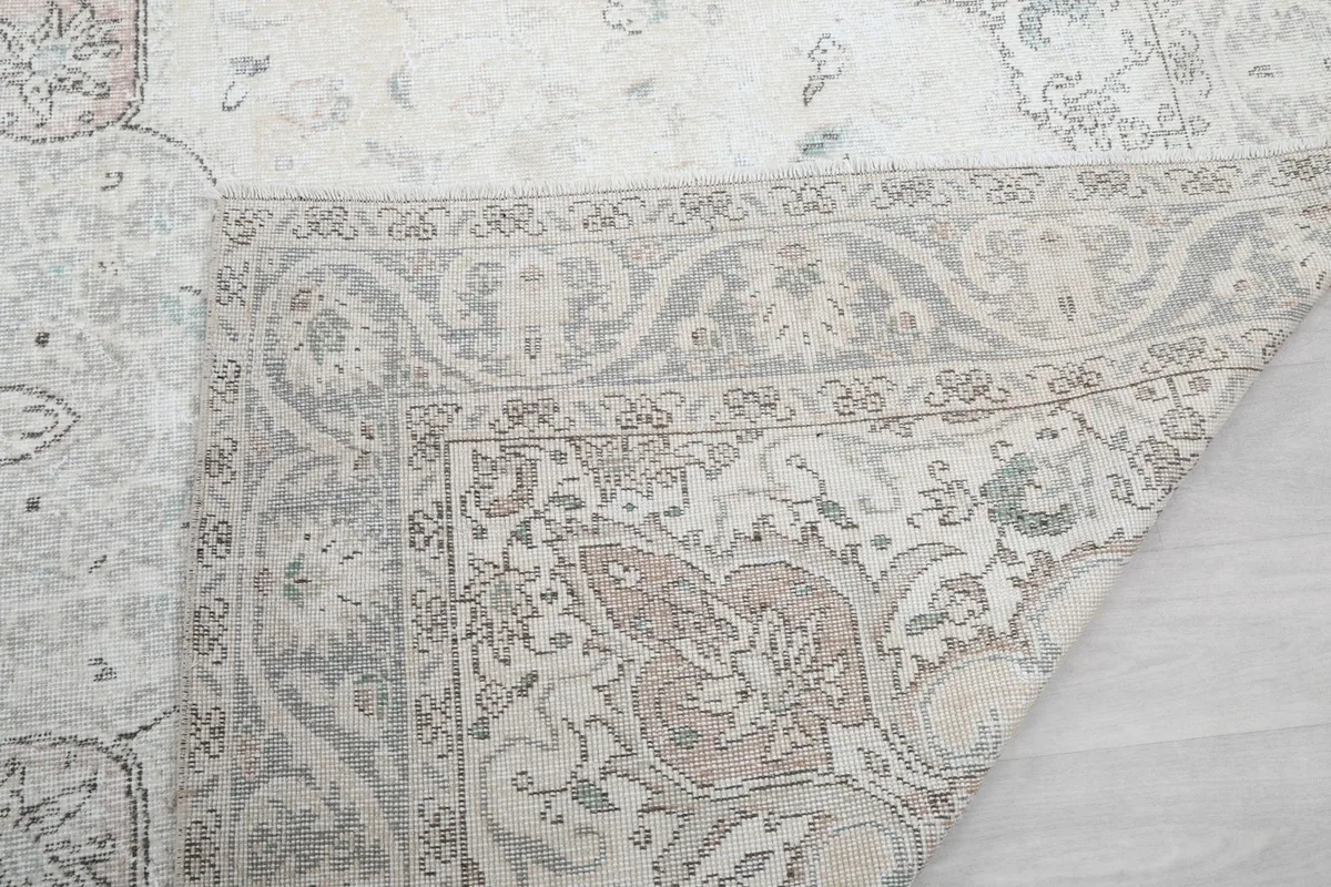 Close view of the rug's border and a folded corner, revealing its craftsmanship