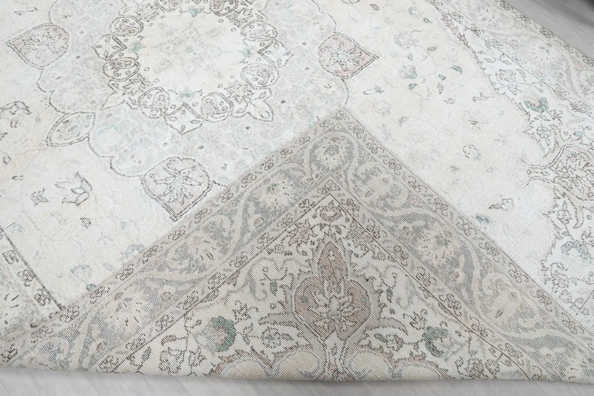 Folded corner showing the reverse side of the hand-knotted rug and its foundation