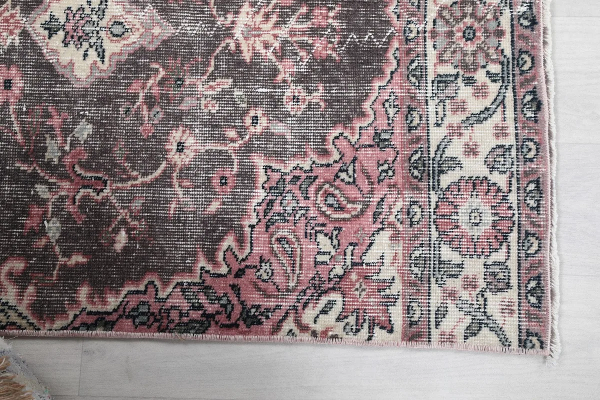 Close-up of the runner's border, featuring rose and ivory floral patterns with charcoal accents
