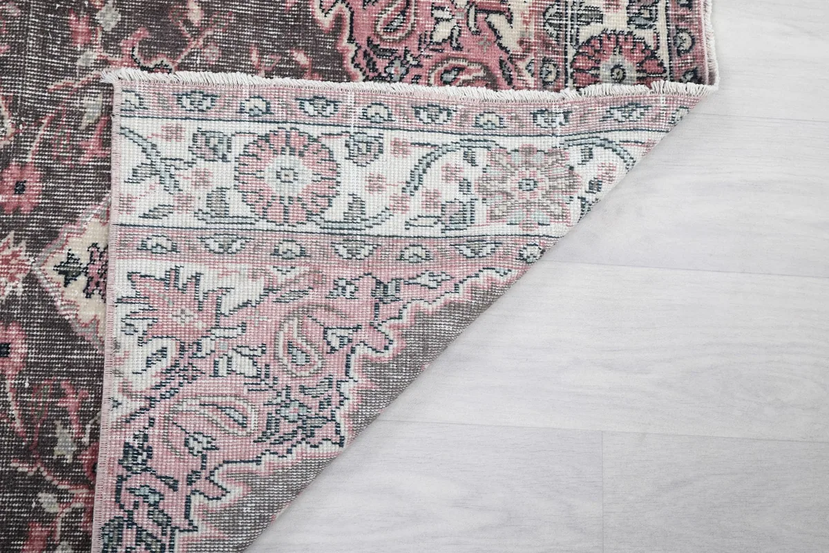 Another view of the runner's corner folded, revealing the tight hand-knotting on the cotton foundation