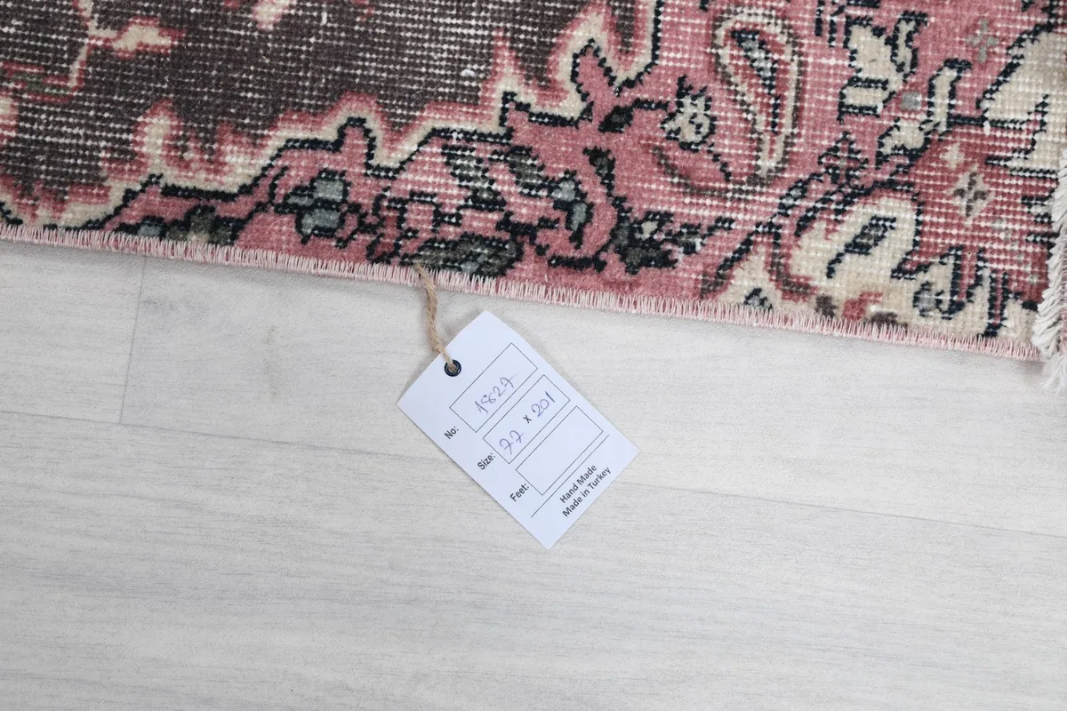 Close-up of the rug's tag with size information and 'Handmade' label