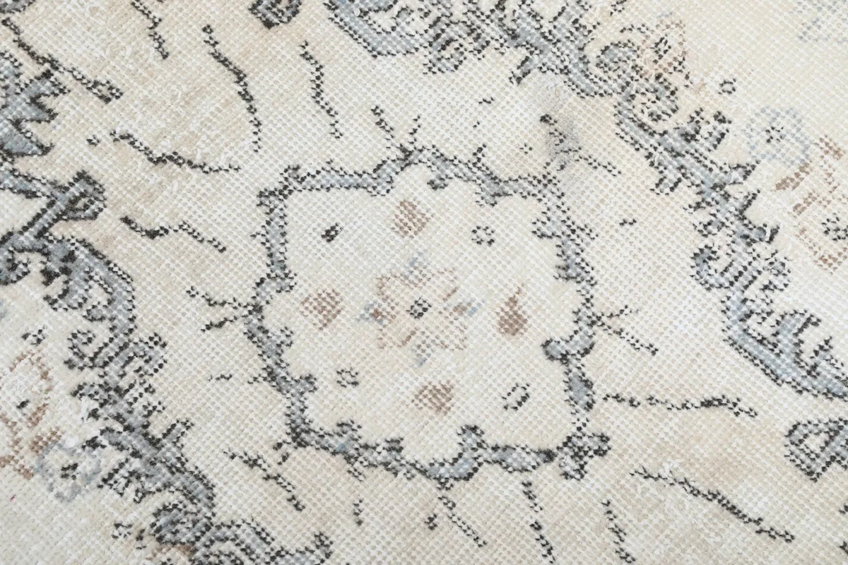 Detailed close-up of the central medallion, showing individual knots and subtle color variations