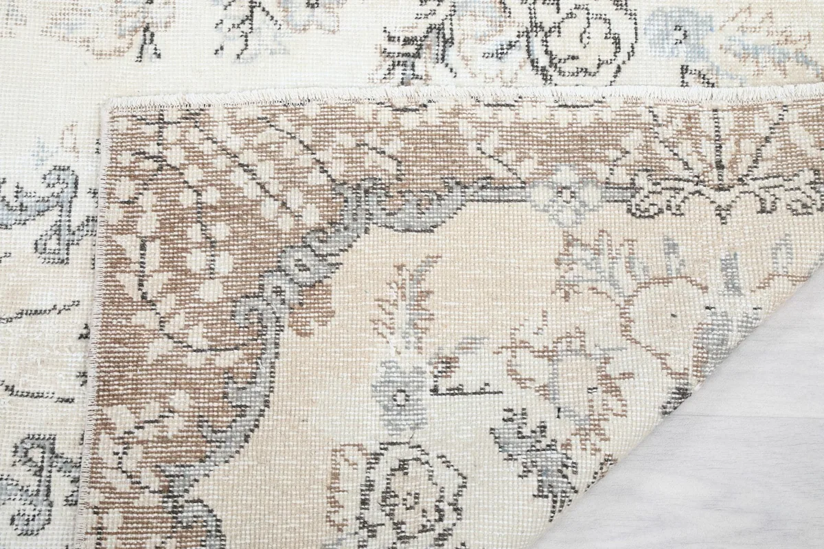 Another view of the rug's corner folded, highlighting the craftsmanship and material