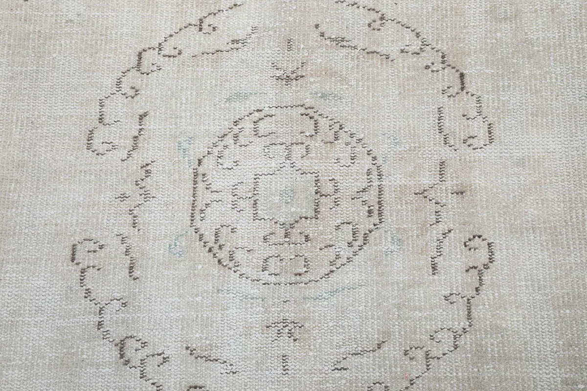 Close-up detail of the central medallion motif and surrounding patterns on the rug
