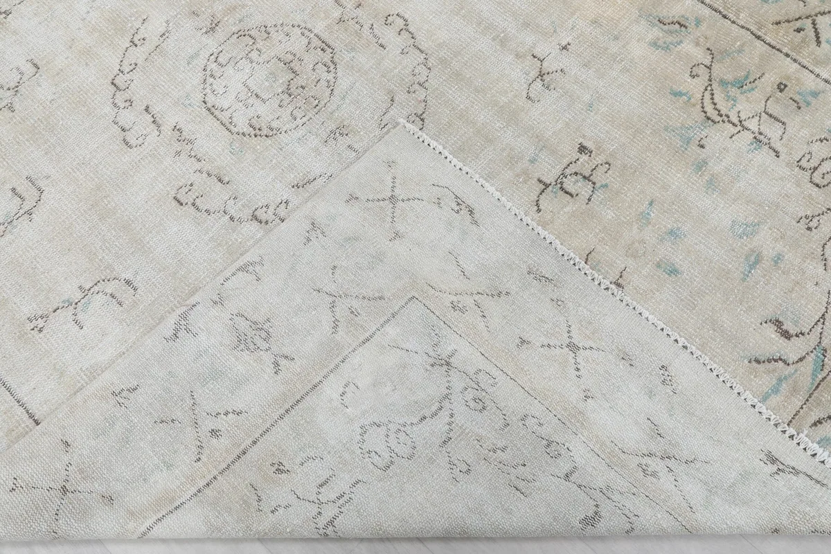 Underside view of the rug, revealing the hand-knotted cotton foundation