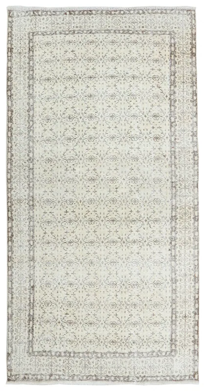 Full top view of the ivory and gray vintage Anatolian rug on a white background