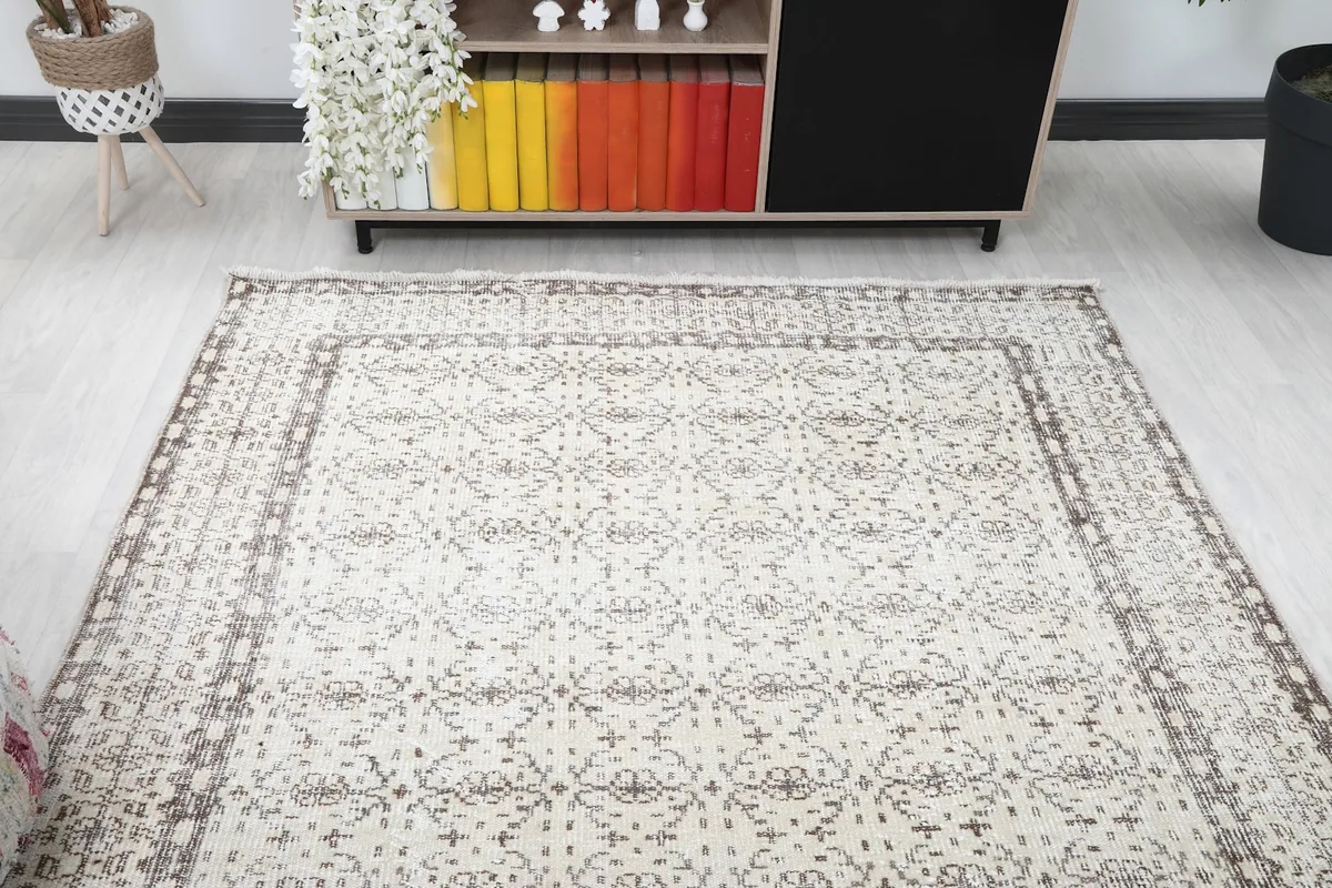 View of the vintage rug from one end in a room, showing its length and pattern flow
