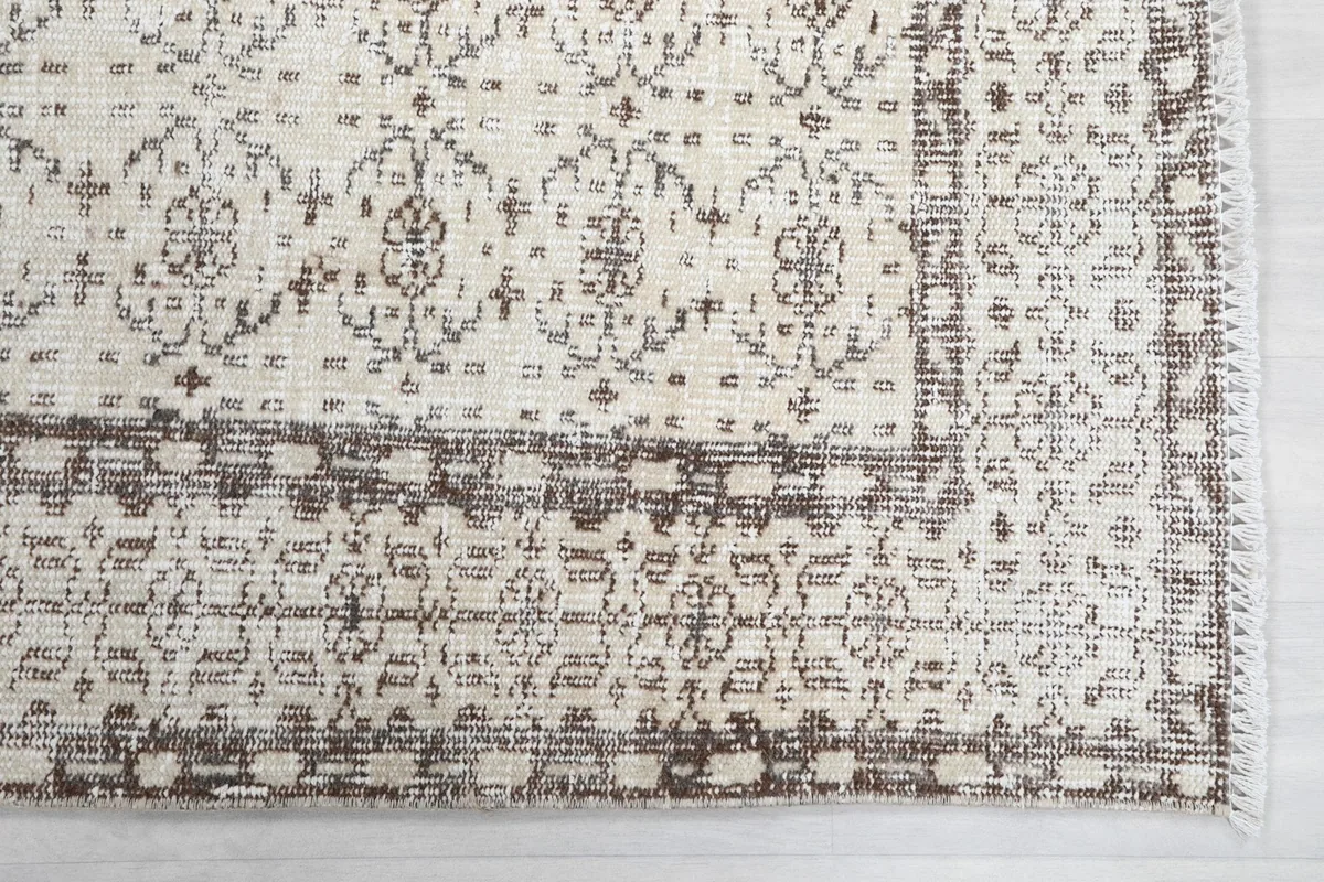 Detailed view of the rug's border and corner, highlighting the intricate geometric design