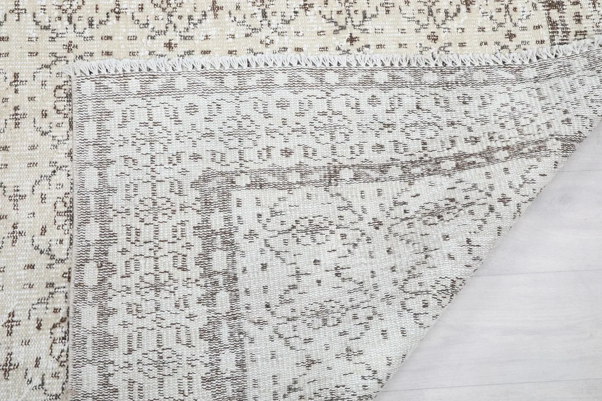 Close-up of the rug's back and edge, showing the tight knotting and construction