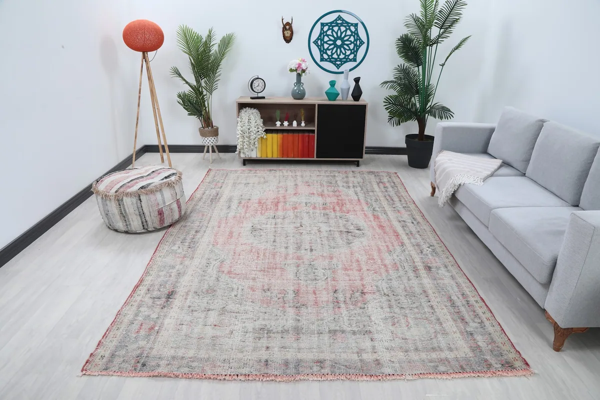 Vintage Anatolian area rug in a modern living room setting, showcasing its size and colors.