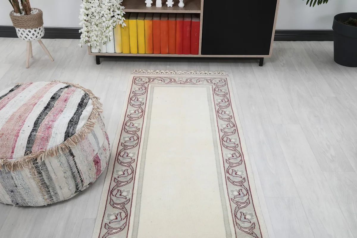 Overhead view of the runner in a room, focusing on its central placement and the full border design.