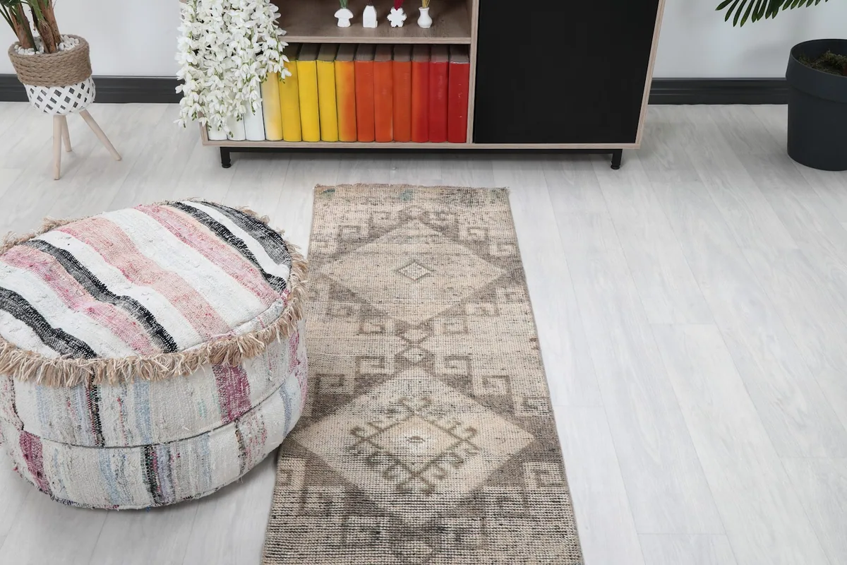 Overhead view of the runner in a room, highlighting its placement near a decorative pouf.