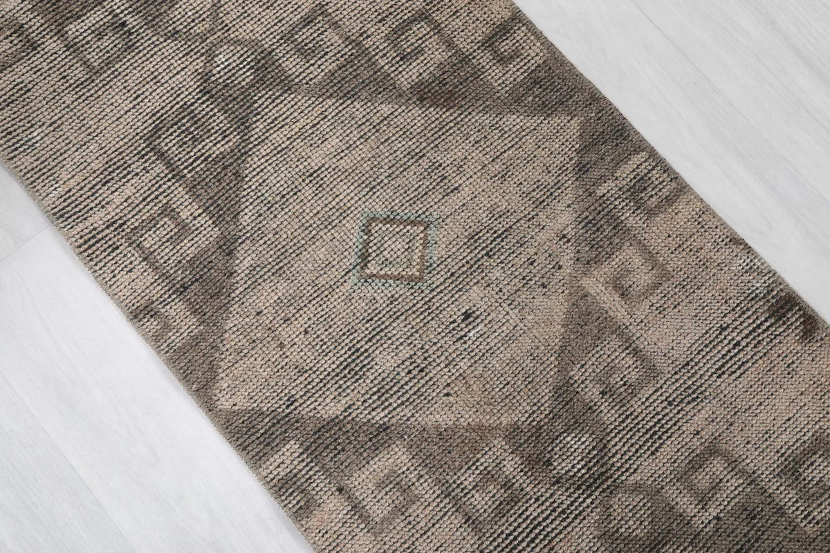 Close-up of a central geometric motif with subtle color variations and wear.