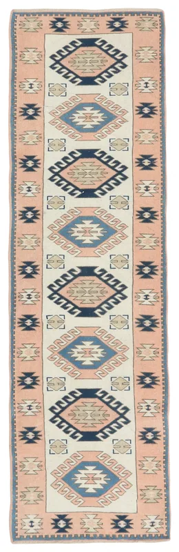 Full overhead view of the rose and ivory tribal geometric runner rug