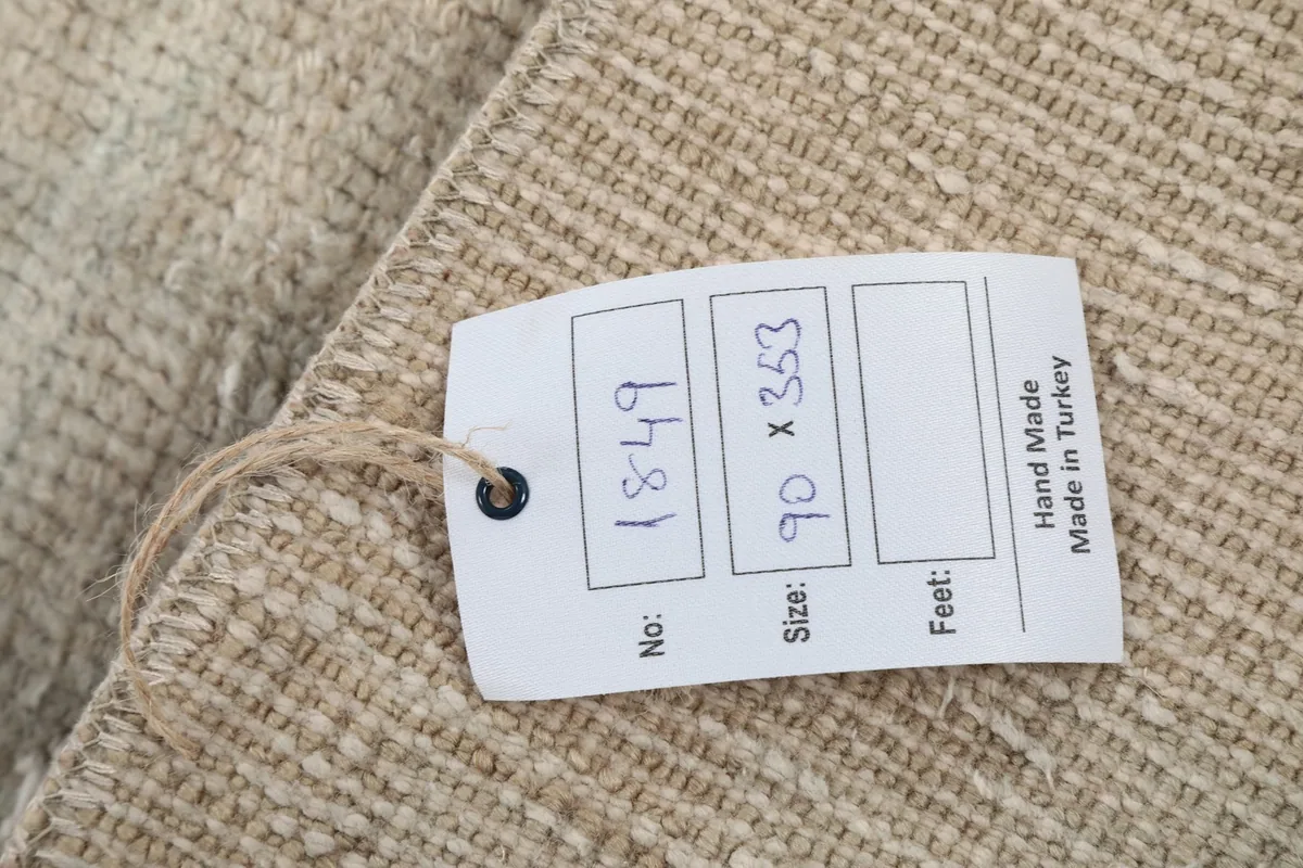 Close-up of the product tag, indicating the rug's identification number and size.