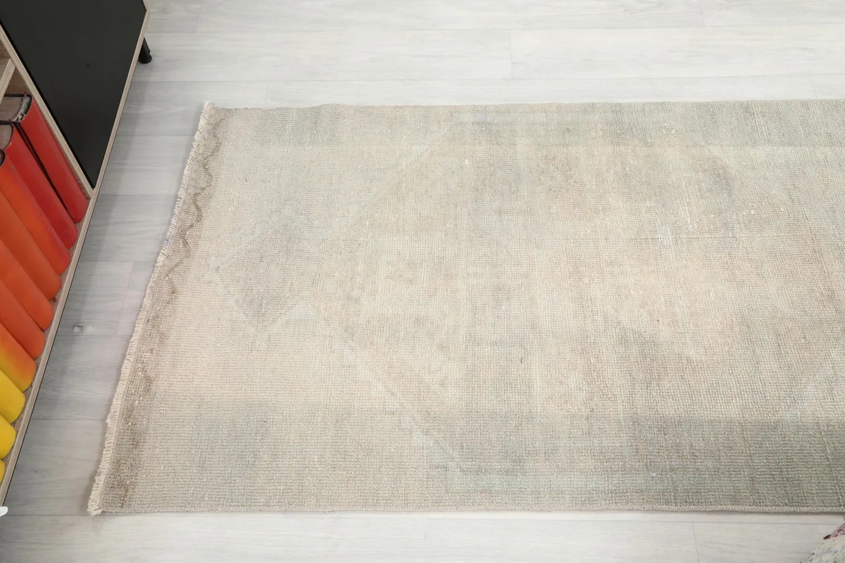 Overhead view focusing on one end of the runner, showcasing its rectangular shape and faded appearance.