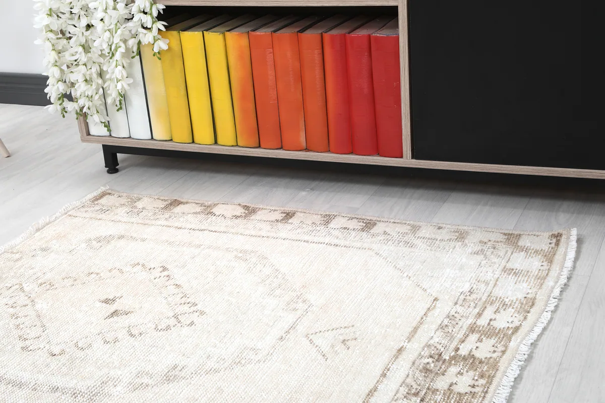 Close-up of the Cream Tribal Medallion Rug, highlighting the border and central design from an angle