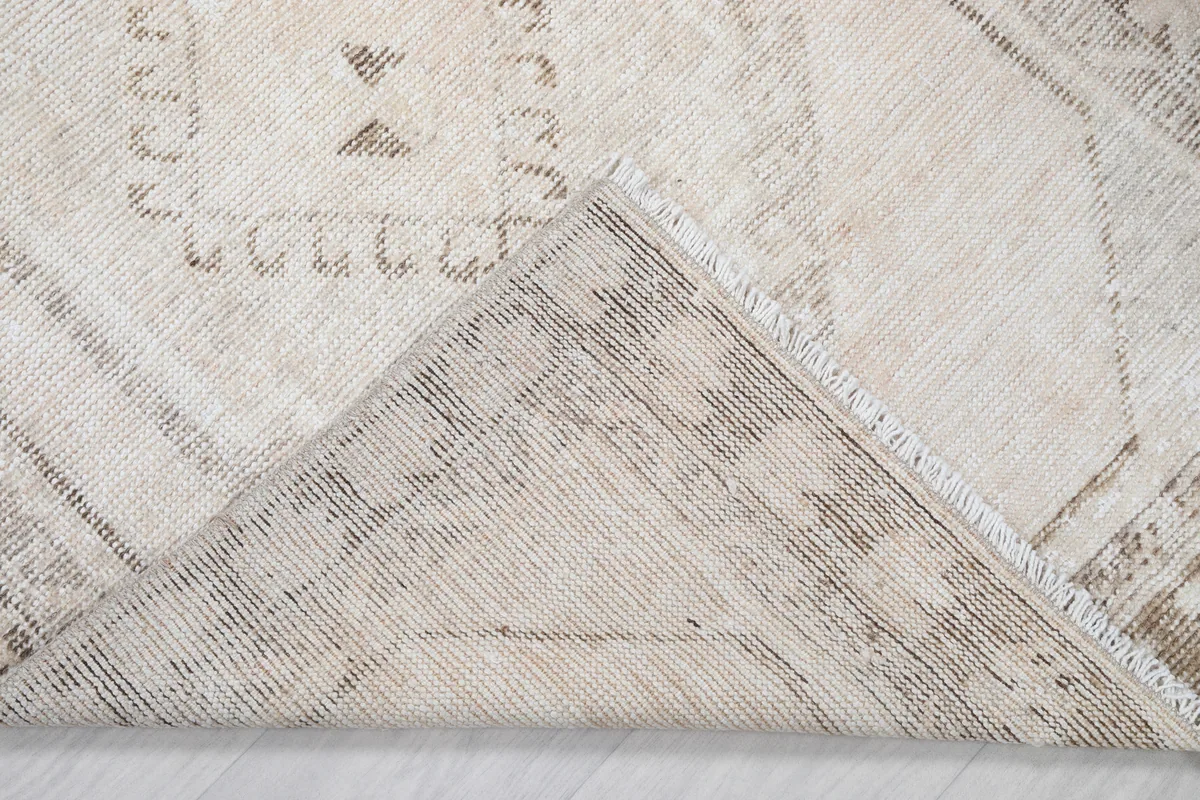 Underside view of the Cream Tribal Medallion Rug, showing the hand-knotted construction