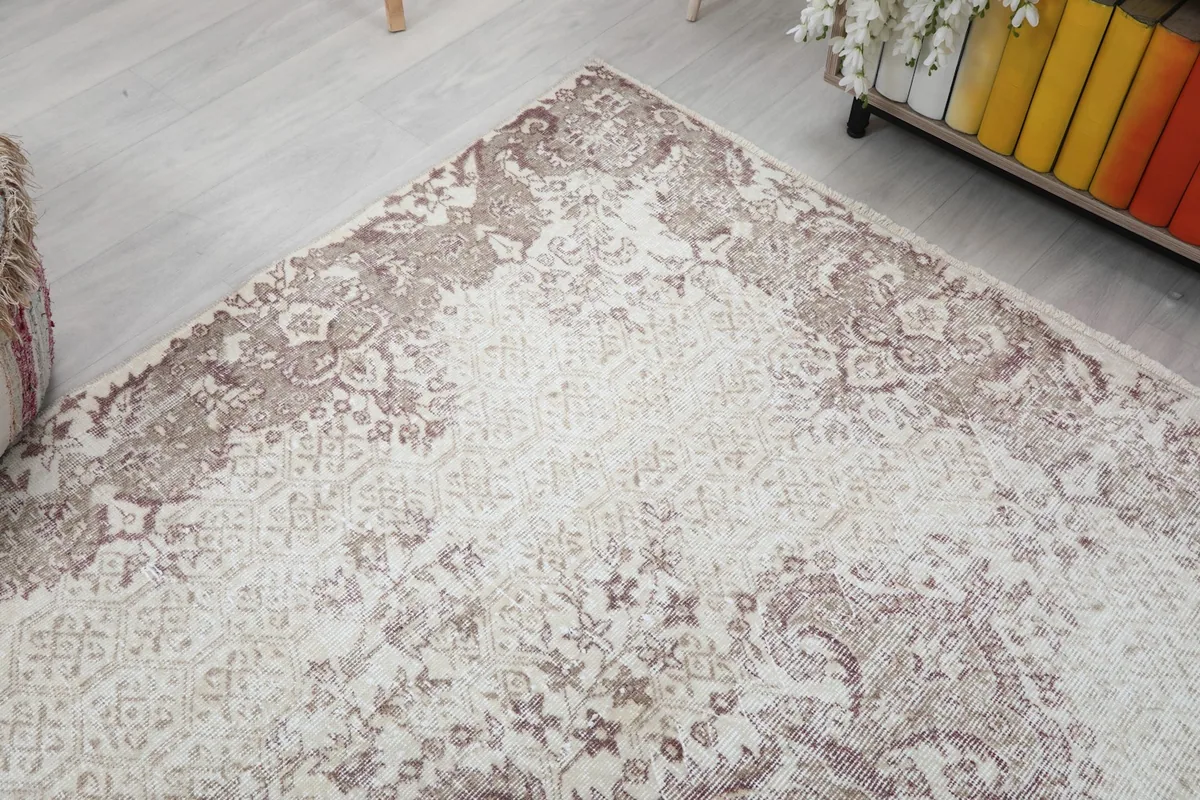Diagonal view of the vintage rug, showing the border and field patterns