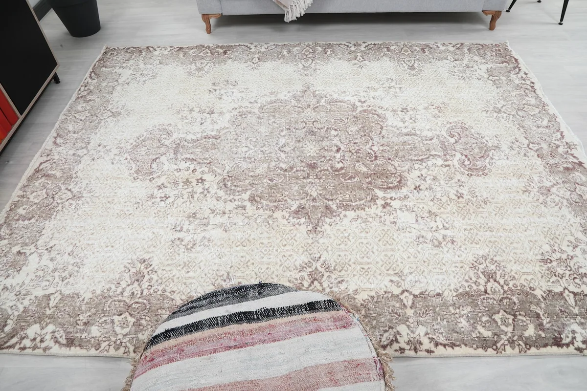 Full overhead perspective of the ivory and rose vintage rug in a home setting