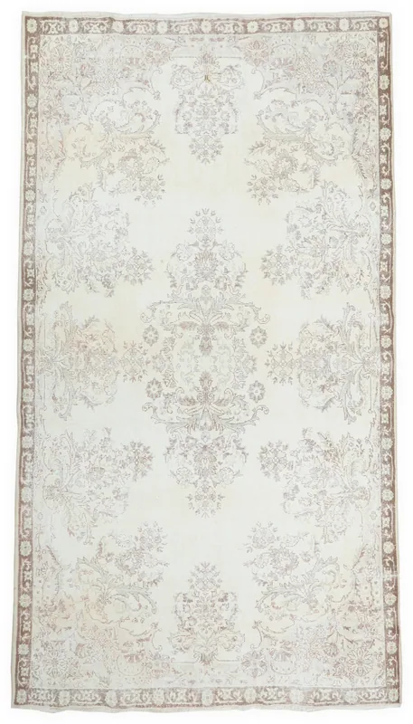 Full overhead view of the 6x10 ivory and brown floral vintage Anatolian rug