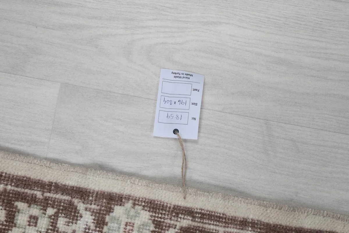 Tag displaying the rug's origin, size, and material, confirming its authenticity