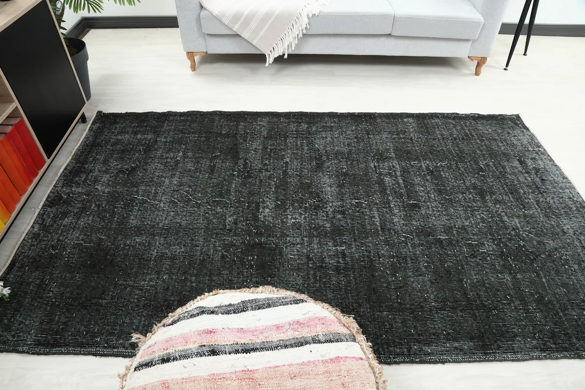 View of the rug in a room setting, focusing on its integration with a light-colored sofa.