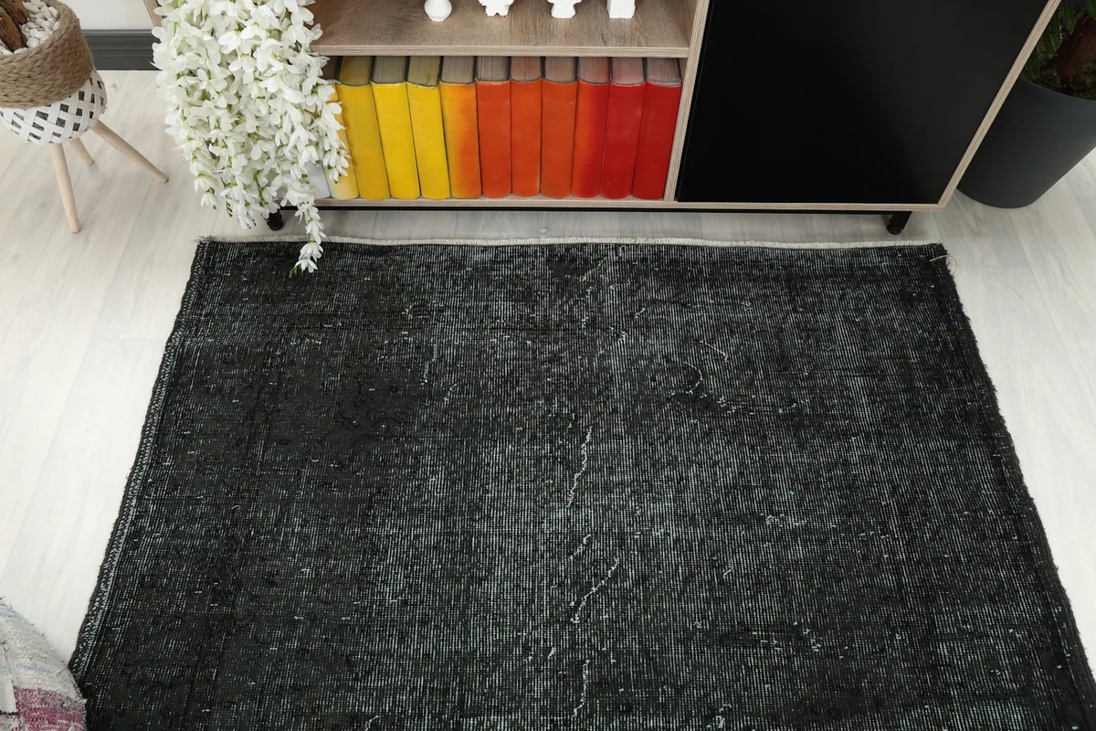 Overhead view of the rug, showcasing its rectangular shape and overall distressed pattern.