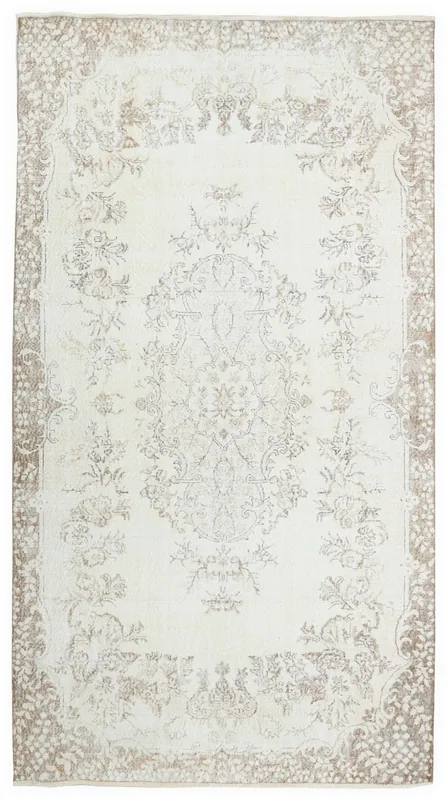 Full top view of the vintage 6x10 ivory and beige medallion floral rug