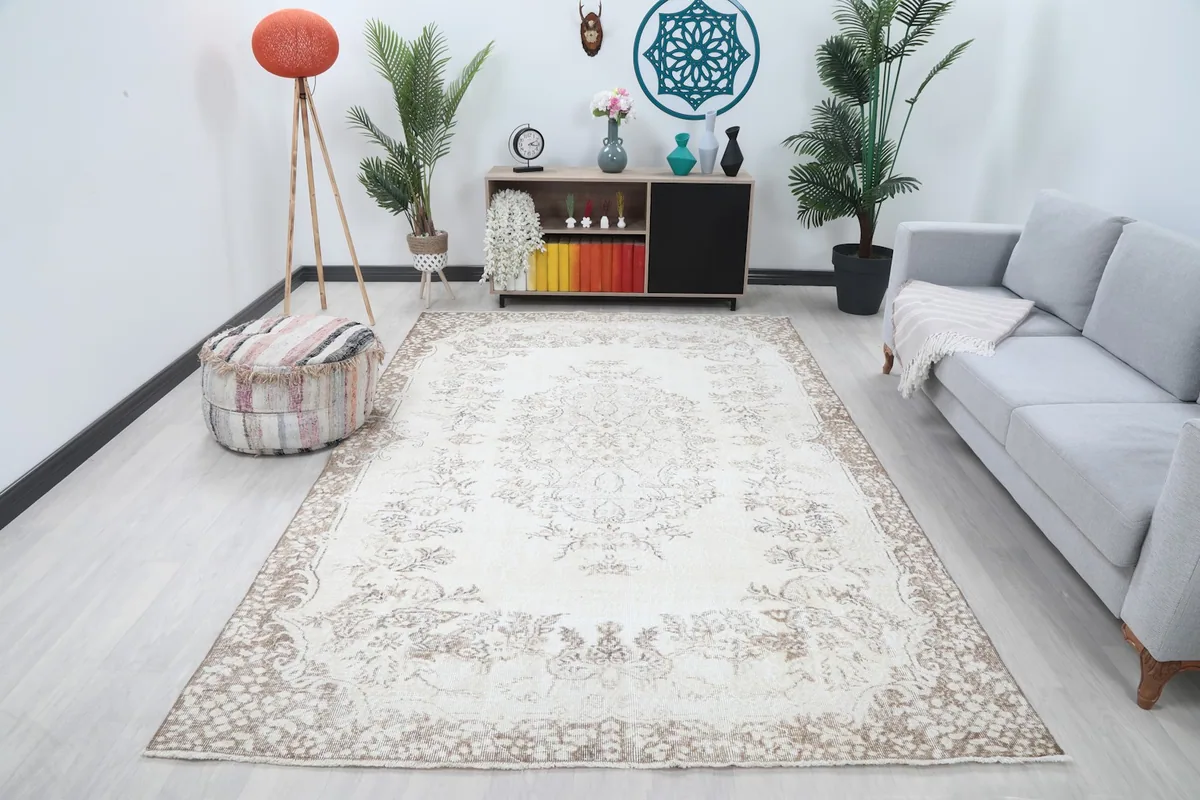 Ivory and beige area rug displayed in a living room setting