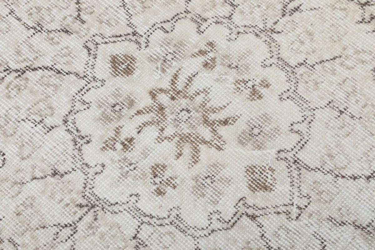 Detailed close-up of the intricate patterns within the rug's medallion