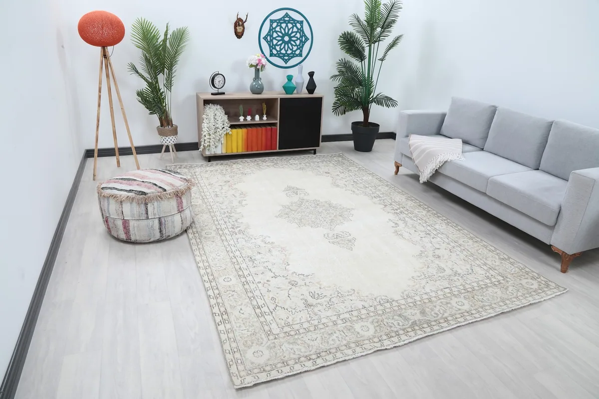Vintage Anatolian rug with ivory field and gray motifs in a spacious room