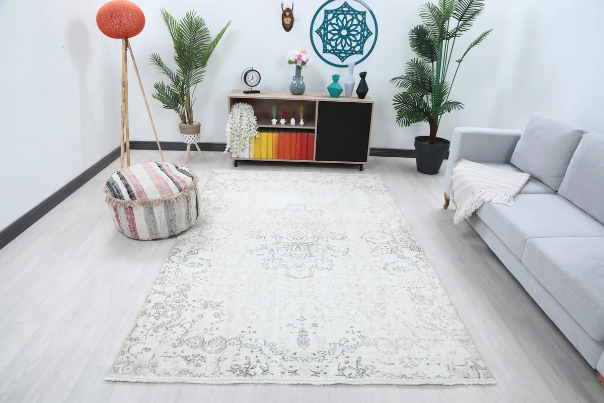 Ivory and gray vintage rug placed in a modern living room setting