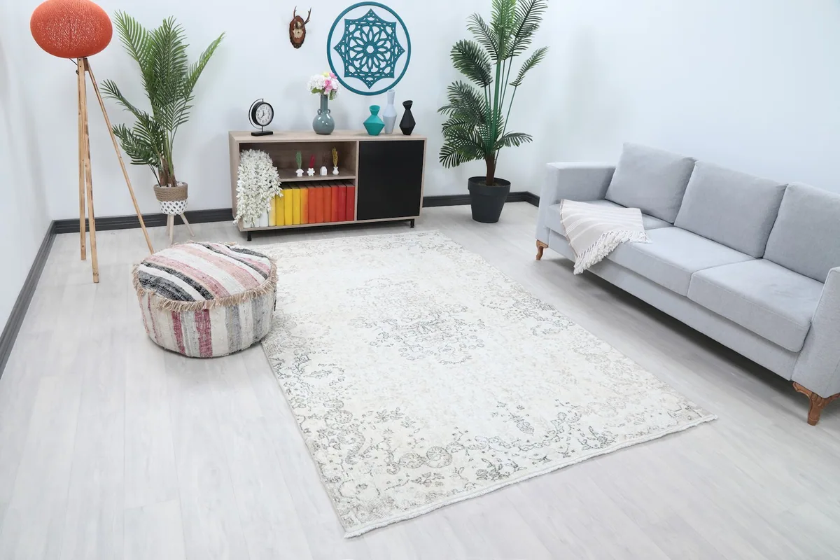 Angle view of the ivory and gray vintage rug in a living room with light decor