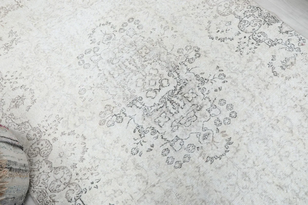 Overhead detail of the central medallion and surrounding faded motifs