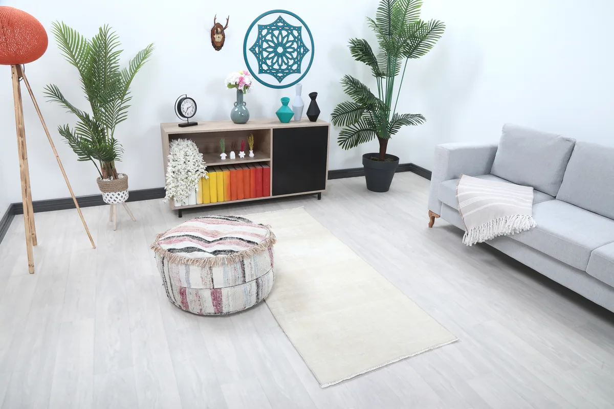 Beige Minimalist Vintage Runner viewed from an angle in a room setting, highlighting its long, narrow shape.