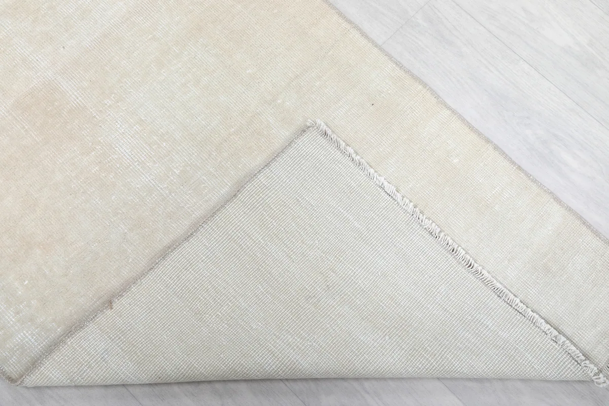 Underside of the Beige Minimalist Vintage Runner, showing the cotton foundation and hand-knotted construction.