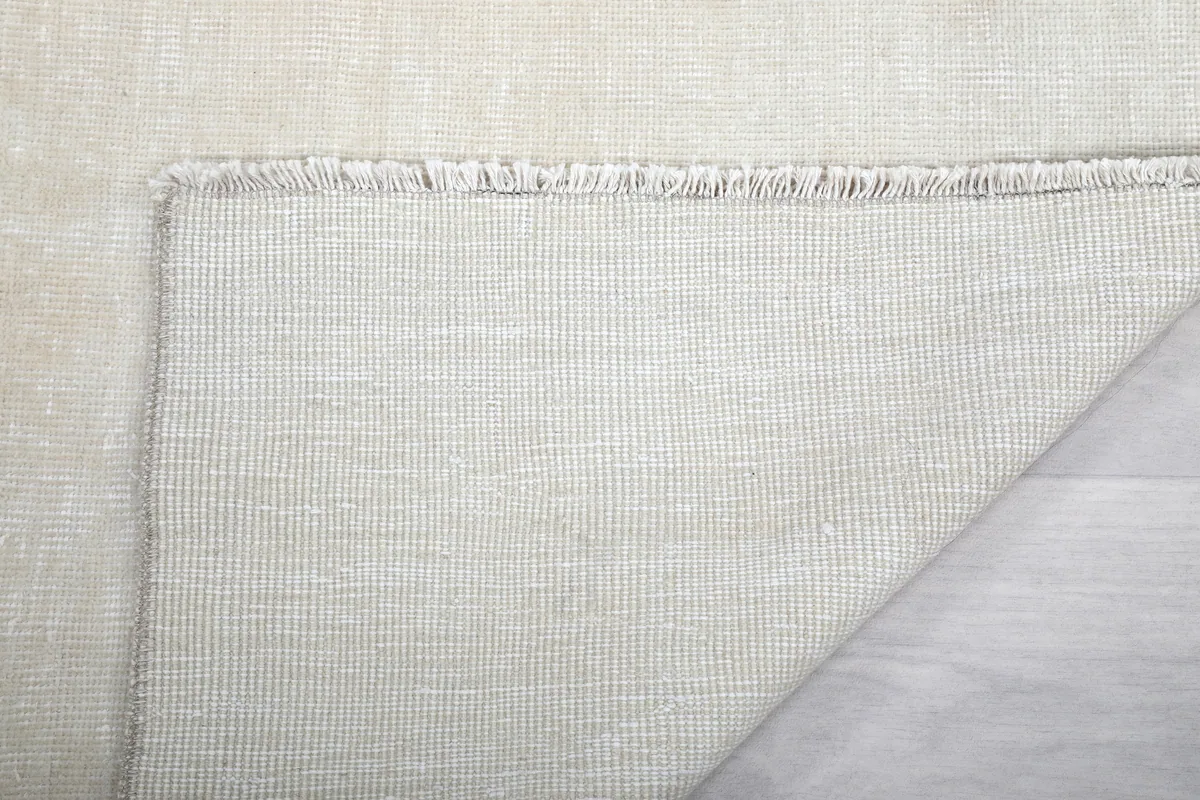 Close-up of the back of the Beige Minimalist Vintage Runner and its fringe, confirming the hand-knotted craftsmanship.