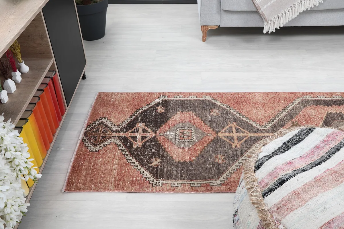Top-down view of the runner rug in a room with furniture, emphasizing its size and placement