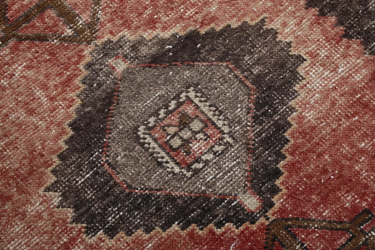 Close-up of a central charcoal and beige geometric motif with intricate details