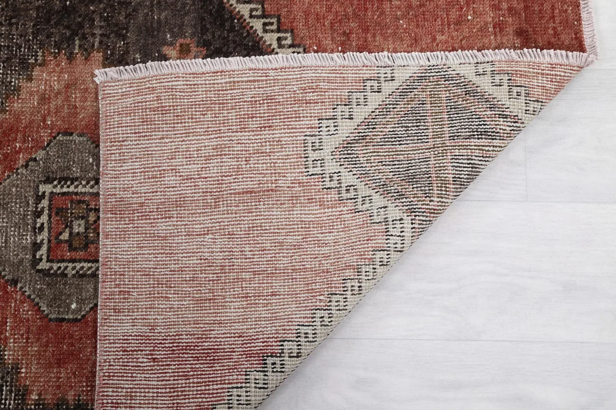 Another view of the rug's back, revealing the knotting and natural fibers