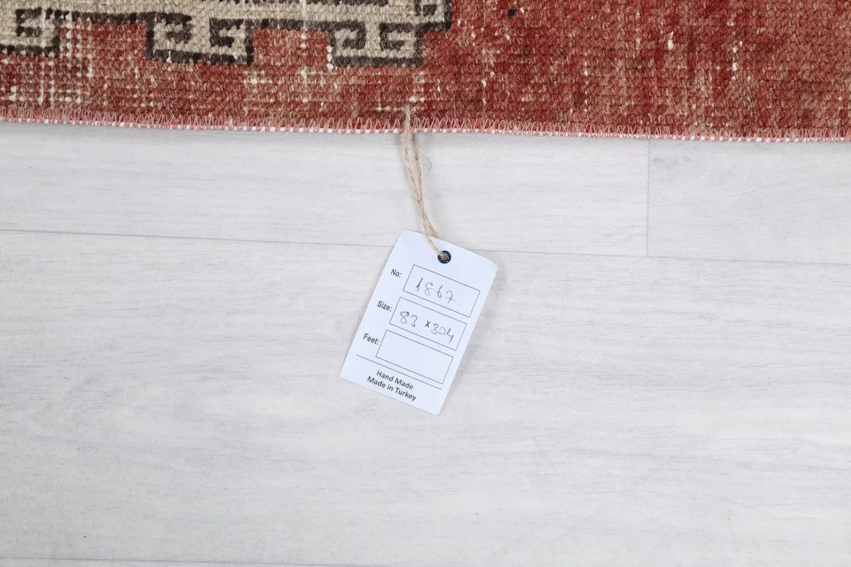 Close-up of the rug's tag, indicating it is hand made in Turkey