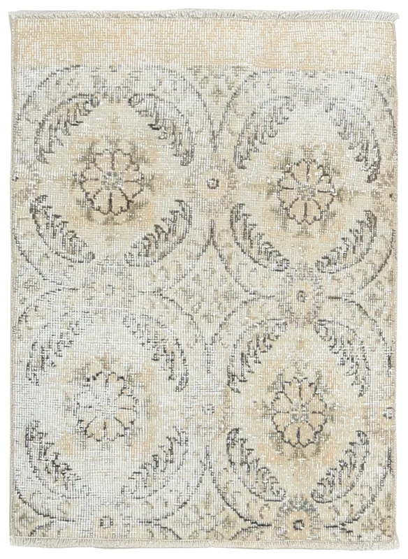 Full top view of the ivory, brown, and gray floral geometric vintage rug