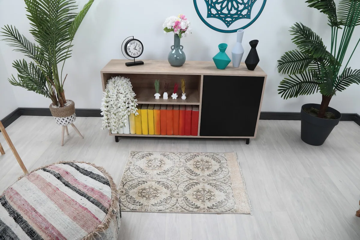 Overhead view of the ivory floral rug in a room setting, showing its placement