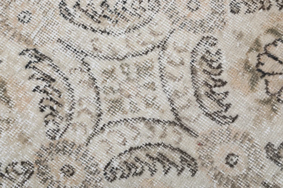 Macro detail of the hand-knotted wool pile and faded brown and gray colors
