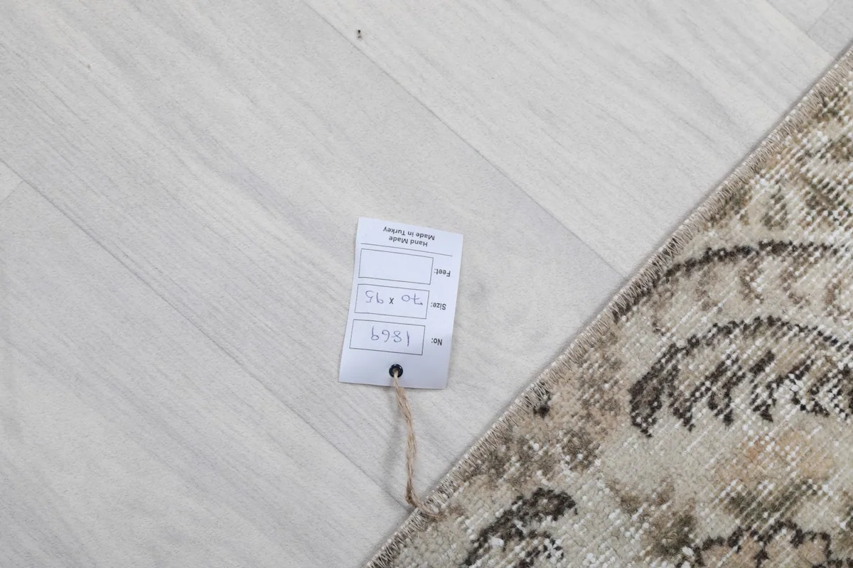 Care tag attached to the rug, displaying measurements and item number