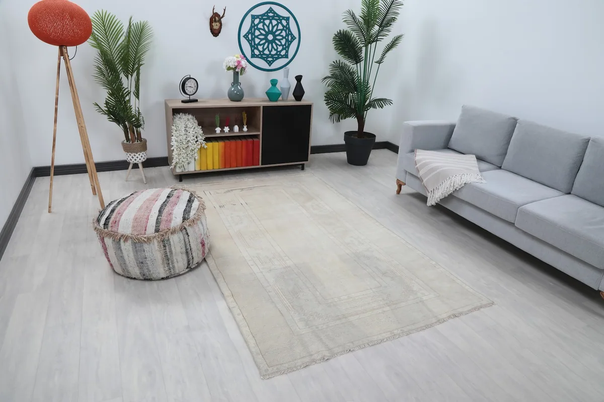 Angle view of the cream geometric rug in a living space, showing its placement relative to furniture.